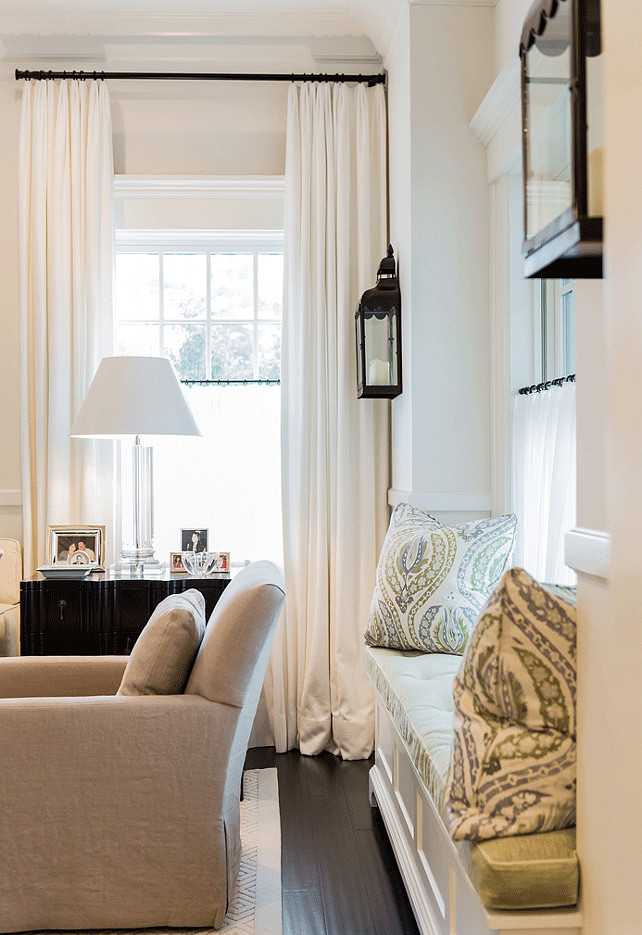 Living Room Window Seat. Living Room Window Seat Flanked by Lantern Sconces. #LivingRoom #WindowSeat #LanternSconces Brookes and Hill Custom Builders.