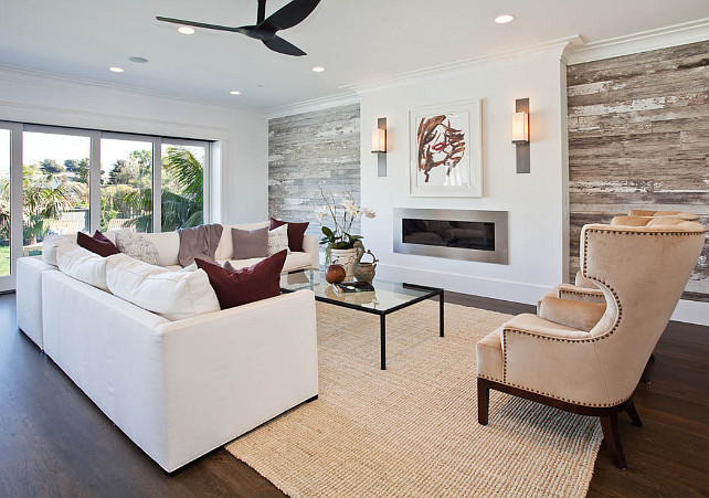 Living room with distressed wood. Living room with reclaimed ship lap wall. This living room features reclaimed shiplap on the fireplace wall. #livingroom #shiplap #wall #reclaimedwood #distressedwood