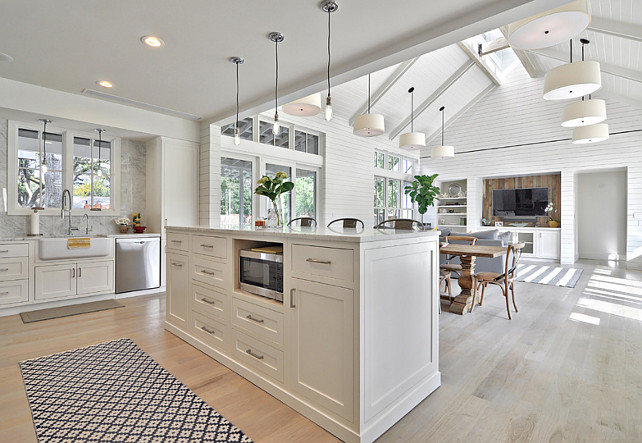 Open Floor Plan Kitchen and Family Room with Shiplap Wall and whitewashed hardwood floors. Redbud Custom Homes.