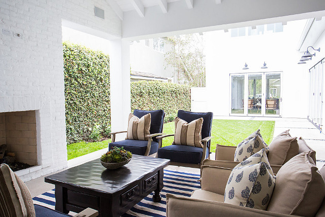 Oudoor Furniture and Fabric Ideas. Beautiful covered patio with outdoor fireplace, outdoor furniture covered in blue and white outdoor fabric. Blackband Design