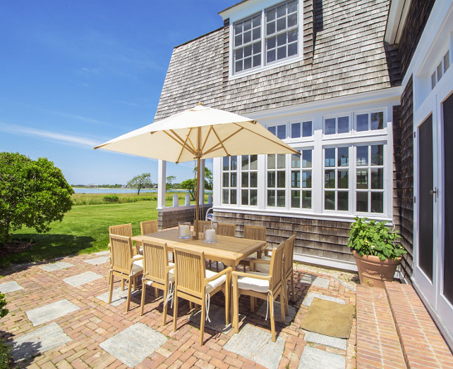 Patio. Beach house outdoor patio with brick flooring. Teak furniture is set on a brick patio in this beachfront house. #BrickPatio #Patio #Brick #Flooring #Teak