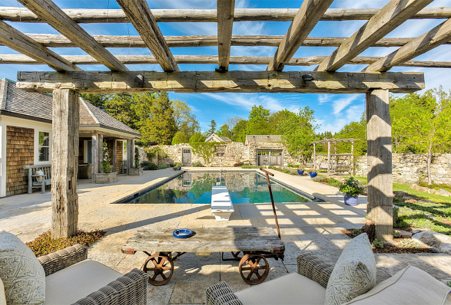 Pool Pergola. Backyard with pool, pool house and pergola. A pergola, made of reclaimed wood beams, offer a great view of the pool. #backyard #pergola #pool #poolhouse