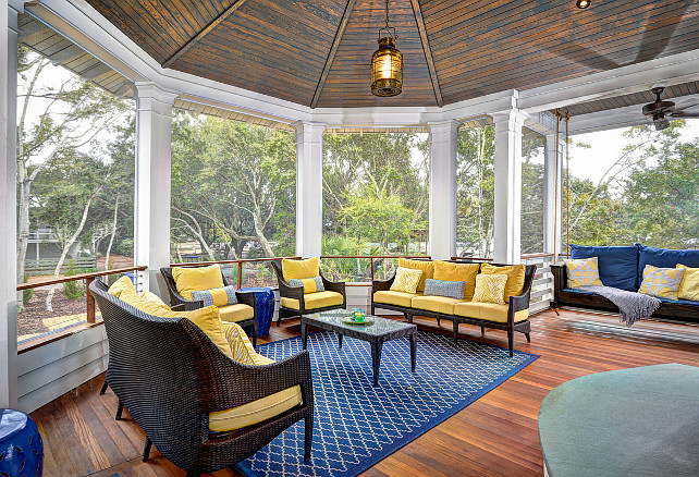 Porch. Back Porch. Outdoor Rug. Blue area rug. Hanging chair. Swing. Porch Swing. Porch Swing Pillow. Porch Swing Cushion. Octagonal pendant light. Swing bed. Swingbed. Wood ceiling. Yellow cushions