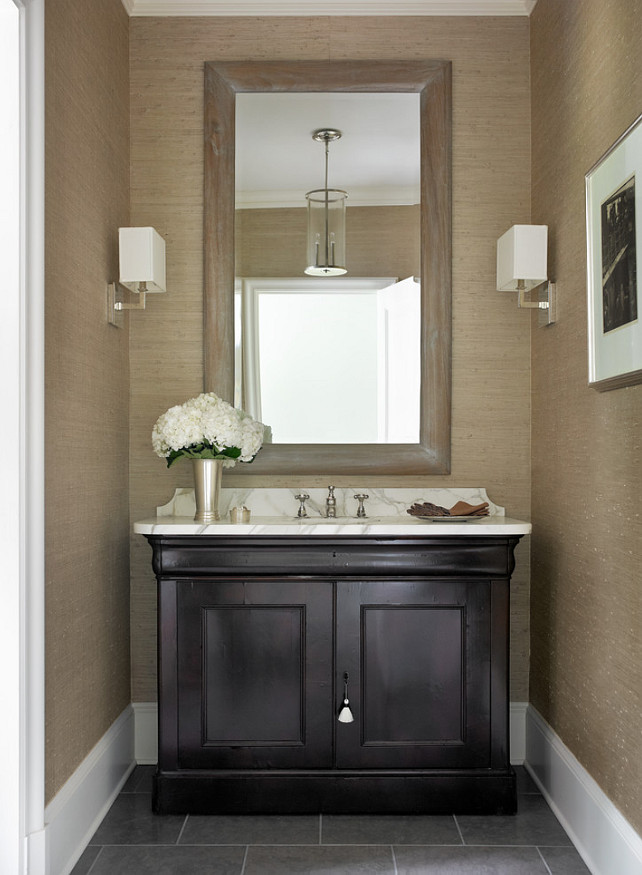 Powder room with wallpaper. The wallpaper in this powder room is the Philip Jeffries Metallic Paper Weaves in color Titanium. Interior Design by Beth Webb Interiors.