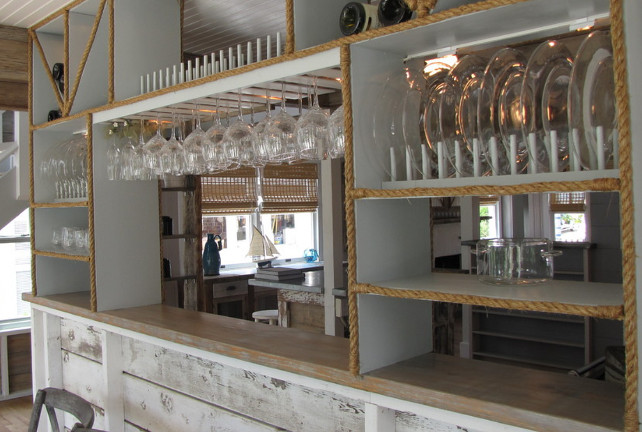 This rustic cottage features an unique kitchen with custom-made shelving with rustic wood cabinet, jute and open shelving.