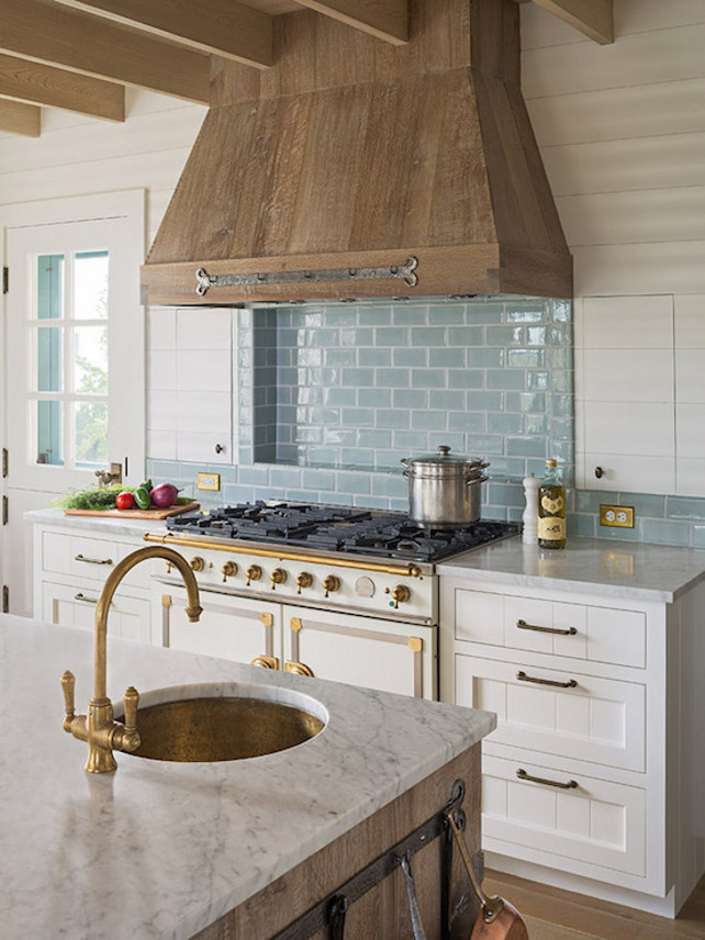 Rustic French Kitchen. French kitchen with wood plank ceiling over a barn board kitchen island topped with a white marble countertop framing a hammered copper prep sink and brushed brass faucet. #FrenchKitchen Dearborn Builders