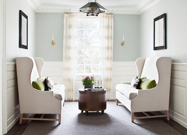 Seating Area. Seating Area Furniture Ideas. Seating Area Design. Seating Area Decor. #SeatingArea This cozy seating area boasts gray blue paint ("Benjamin Moore HC-147 Woodlawn Blue" ) on upper walls and stacked wainscoting on lower walls. Linen, wingback settee adorned with green velvet pillows and chocolate brown pillows face each other across from round, metal, footed, coffee table atop geometric jute rug. Alisberg Parker Architects.