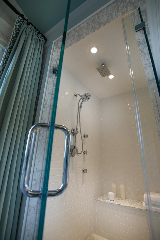 Shower Ideas. Bathroom Shower Ideas. The sleek glass shower is completely lined in white subway tile and features a convenient seat, recessed lighting, and both a wall-mounted and overhead showerhead. #Shower #Bathroom