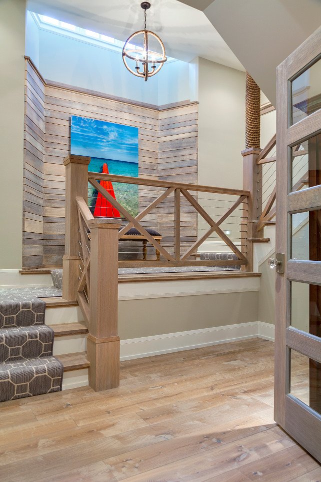 Staircase Railing. Coastal Inspired Staircase Railing. Driftwood wall, plank hardwood floors, plank hardwood staircase with wood and rope railing. #Staircase #Railing #CoastalHome Great Neighborhood Homes.