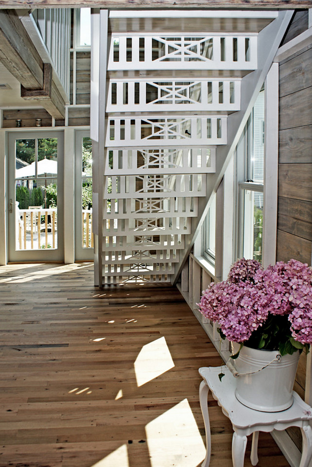 Staircase. Beach cottage Staircase. Staircase with latticework. Custom millwork out-in stairwell inspired by local yacht club motif. #Staircase #Stairwell #Coastal