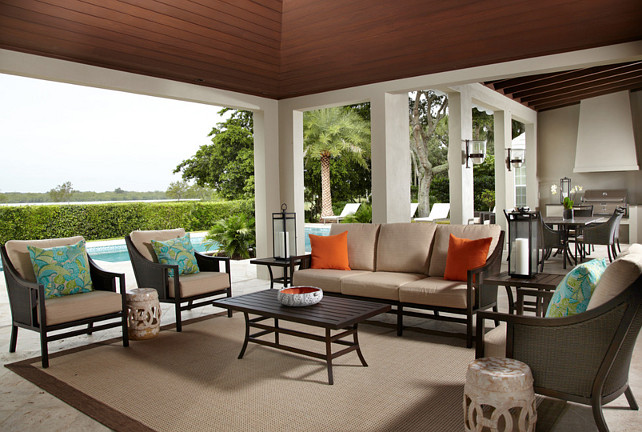 There are two ceiling treatments defining these two outdoor rooms. The seating area has a wooden trey ceiling, and the dining and grilling area has exposed beams. Pineapple House Interior Design.