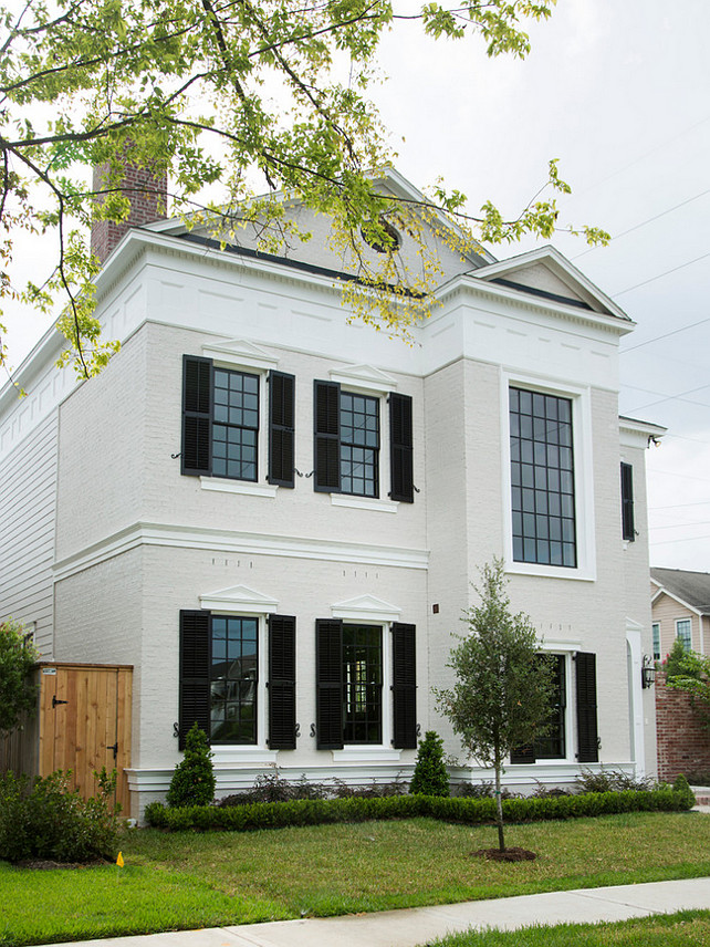 Traditional home with white exterior and black window shutters. #TraditionalHome #HomeExterior #WhiteExterior #BlackShutters Whitestone Builders.