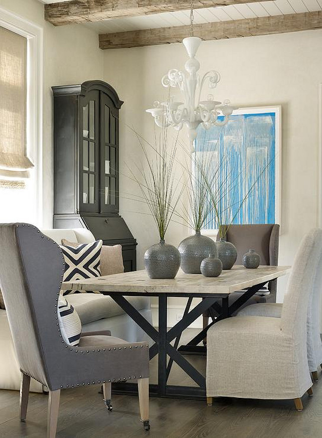 Transitional Dining Room. Transitional Dining Room with X Based Dining Table, natural linen slipper chairs and gray wingback captain dining chairs. Interior Design by Beth Webb Interiors.