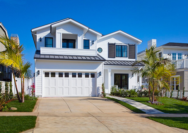 White Exterior Paint Color. White exterior paint color ideas. White exterior with charcoal metal roof and charcoal window shutters. White Picket Fence, Inc.