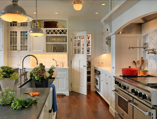 White Kitchen Ideas. This white kitchen has so many great design ideas. Countertop is honed Pietra De Cardosa and the perimeter counters are Blizzard Caesar Stone. The stunning pendants are the Orson Pendants by Remains. Cabinet Paint Color: "Benjamin Moore Decorators White CC-20" #WhiteKitchen