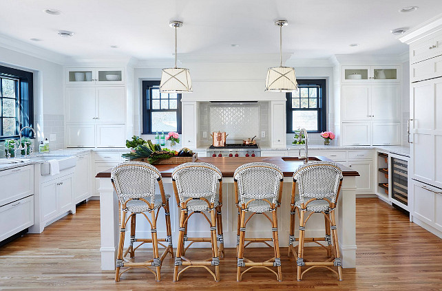 White Kitchen. Kitchen with white cabinet, Serena & Lily Riviera Counter Stool, Grosvenor One-Light Downlight by Sandy Chapman pendant lighting above island, walnut kitchen countertop and Roman granite perimeter countertop. #kitchen Kitchen design by Martha O'Hara Interiors.