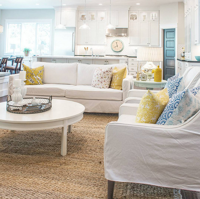 White interiors with pops of color. Beautiful open main floor with white walls, white furniture with pops of color. Lindsay Hill Interiors.