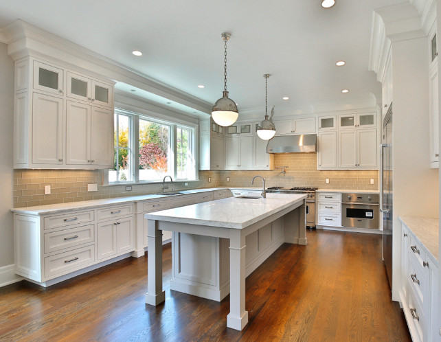 White kitchen with gray island. White kitchen with pale gray island. #Kitchen #GrayIsland #KitchenGrayIsland Blue Water Home Builders.