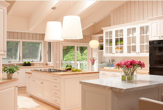 White Kitchen Design. Forget about boring white kitchens! This white kicthe is full of personality with washed wood walls and great lighting. #WhiteKitchen